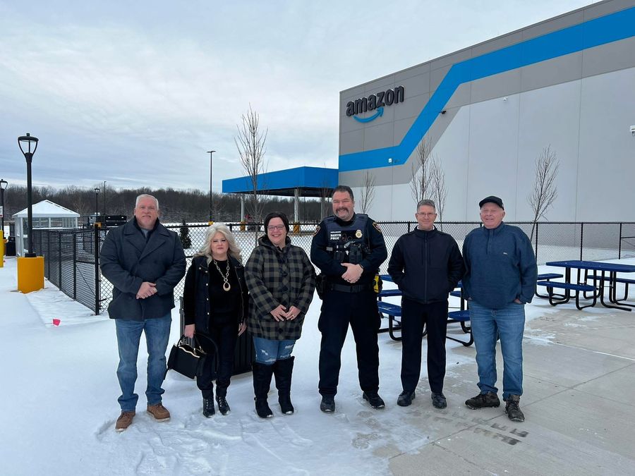 Michael Hovis with township leaders and a Bazetta police officer at the new Amazon facility