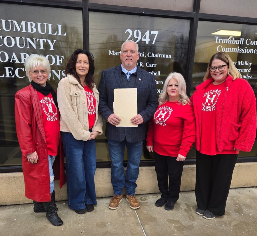 Michael Hovis holding his filing paperwork with supporters in Hovis shirts at the Trumbull County Board of Elections
